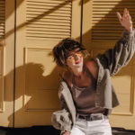 positive-woman-denim-jacket-undershirt-looks-sun-bright-backdrop-brunette-girl-light-pants-sunglasses-poses-yellow-background_197531-28011