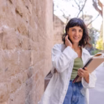 smiling-woman-look-camera-with-workbooks_197531-33515